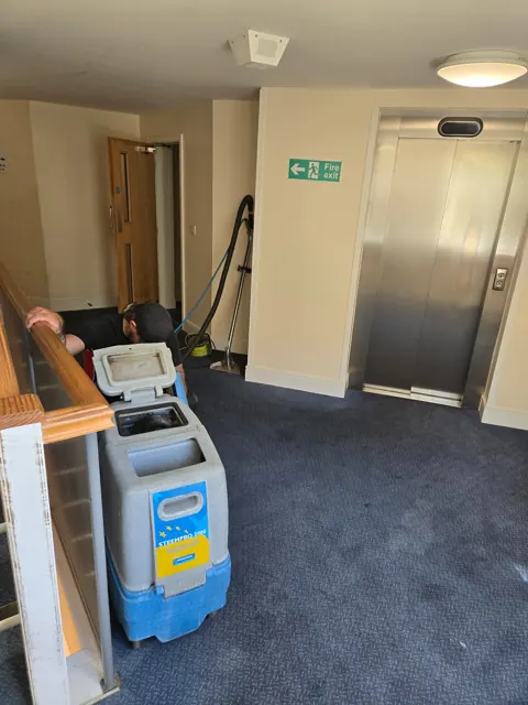Carpet care beside a lift lobby