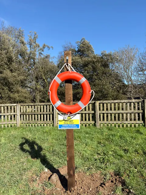 Lifebuoy station beside a pathway
